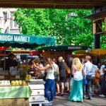 Lively scene at Borough Market in London, filled with people shopping and enjoying the atmosphere.